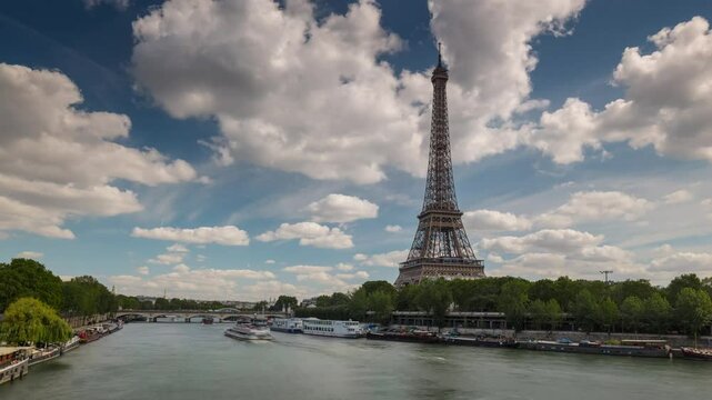 PARIS, FRANCE - OCTOBER 28, 2024: Scenic view of the Eiffel Tower and riverside activities along the Seine River in autumn