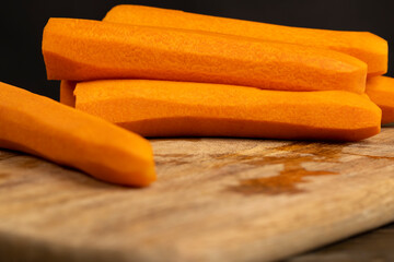 peeled orange carrots on the table during cooking