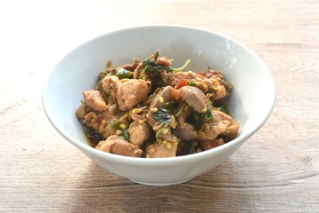 spicy chili stir-fried chicken meat and gizzard couple liver with basil leaf on bowl