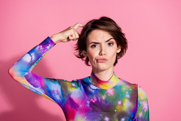 Portrait of pretty young girl scratch head think wear pullover isolated on pink color background