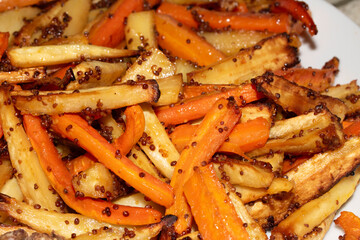 Close Up of Parsnips and Carrots with Honey Mustard Dressing Ready for Roast Dinner