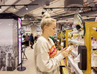 Woman choosing powder and testing makeup brush, palette of powder and foundation .	