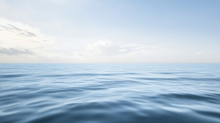 Obraz premium Calm ocean waves under a clear blue sky.