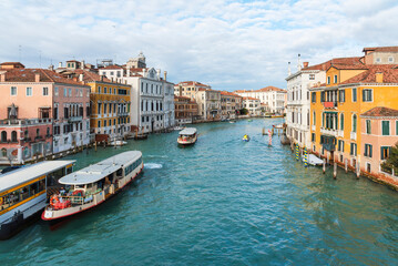 Canal traffic and vibrant buildings along Venice's Grand Canal, Italy.