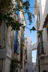 Fototapeta premium White old houses and narrow streets in medieval small touristic coastal town Sperlonga, Latina, vacation in Italy