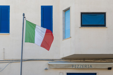 Flag of Italy and Italuan pizza cafe, local pizzeria in Italy