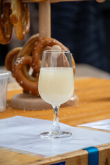 Autumn wine festival in Schengen, Luxembourg on Moselle river valley, tasting of federweisser young wine, neuer wein fermented freshly pessed auxerrois grape juice, or must.