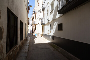 Narrow street leading to archway in spanish town