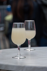 Autumn wine festival in Schengen, Luxembourg on Moselle river valley, tasting of federweisser young wine, neuer wein fermented freshly pessed auxerrois grape juice, or must.