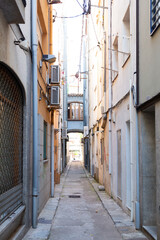 Narrow street leading to archway in spanish town