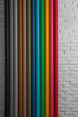Colorful paper backgrounds on brick wall background