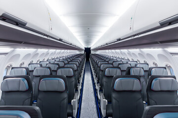 Inside view of empty airplane cabin with modern cabin interior in economy class