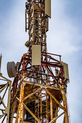 Communication tower with blue sky and clouds