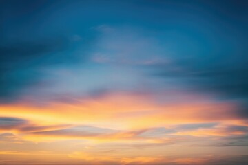 Obraz premium Serene sunset sky with vibrant orange and blue hues, delicate clouds painting a breathtaking scene.