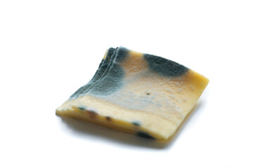 Slices of moldy ,rotten yellow cheese isolated on white background.
