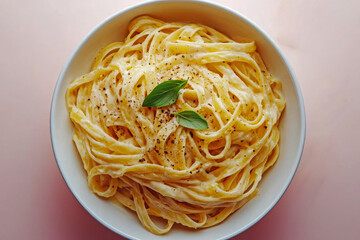 A delightful fettuccine dish garnished with basil in creamy sauce.
