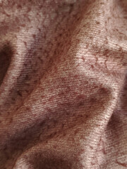 Naklejka premium Crinkled fabric in Mocha Mousse color. Warm brown wool fabric for sewing. Background for text. Textile factory. Brown blanket.