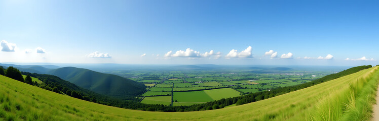 Fototapeta premium Panoramic View Of Green Hills, Meadows, And White Clouds Under A Clear Blue Sky On A Beautiful Day. 00001