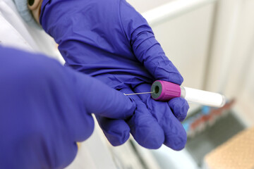 The vial with the liquid is pierced with a syringe for a set of drugs.