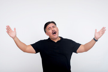 Man expressing strong emotions with hands raised on white studio background