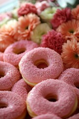 Pink Frosted Donut Delight A Cheerful Bakery Display with Floral Garnish and Sweet Treats