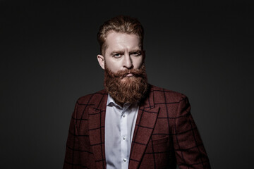 Fototapeta premium Suit on menswear model. Stylish man in business suit. Businessman with beard. Brutal bearded man isolated on grey. Ambitious man in elegant suit menswear. Formal fashion for man. Trendy style