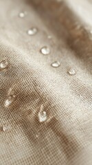 Close up of beige linen fabric with water droplets
