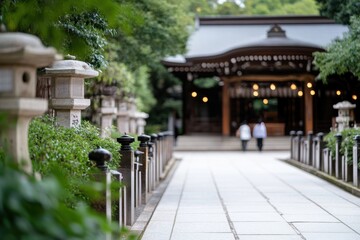 Fototapeta premium This image beautifully frames the entryway of a lush green shrine, showcasing traditional Japanese architecture amidst a serene natural backdrop, ideal for contemplative visits.