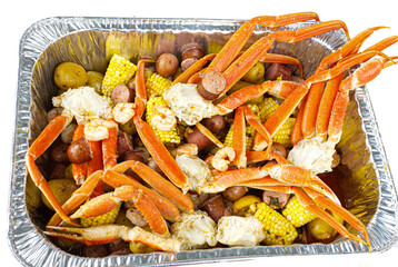 seafood boil with shellfish, Snow crab, corn on the cob, shelled shrimp, sausage, small red and...