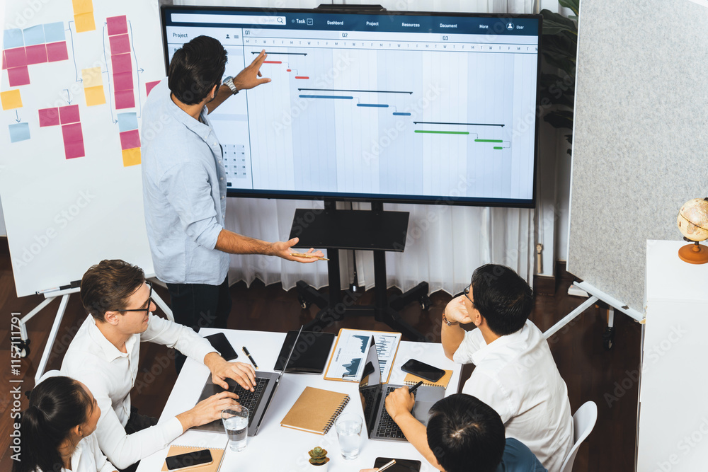 Leinwandbilder Project manager communicate and collaborate with team using project management software display on monitor, tracking progress of project task and making schedule plan at meeting table. Prudent