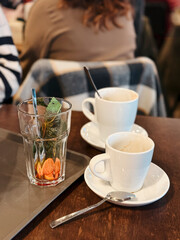 Used dirty tea glass and coffee cups on a tray