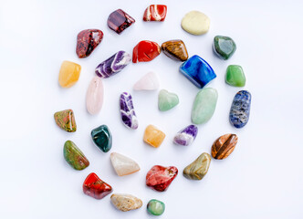 A set of healing minerals (stones) for the chakras. Colorful semi-precious stones in the form of a spiral on a white background. Mineralogy, esotericism, spiritual practices, reiki. 