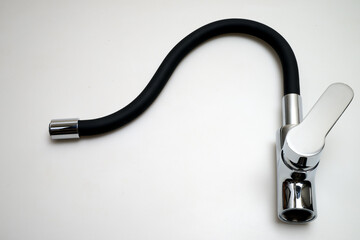 Detail of a Single lever sink mixer black spout chrome saver