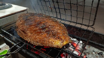Fish grilling on a barbecue with prepare for party