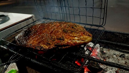 Fish grilling on a barbecue with prepare for party