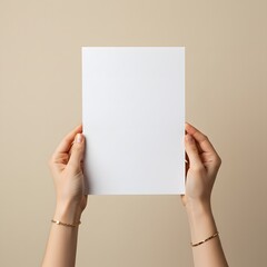 Obraz premium Female hands hold a blank sheet of paper on a beige background. Advertising space