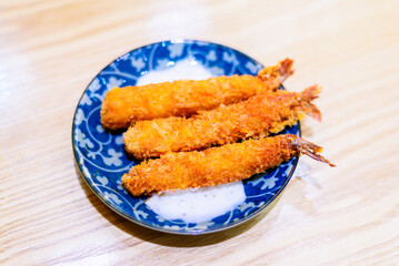 Golden Crispy Breaded Shrimp on Traditional Blue and White Porcelain Plate