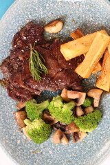 Grilled Steak with Broccoli, Mushrooms, and Yuca Fries