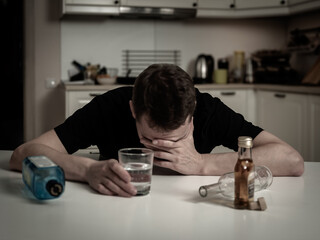 A man suffering from a hangover reflects the consequences of alcoholism, his physical and emotional state.