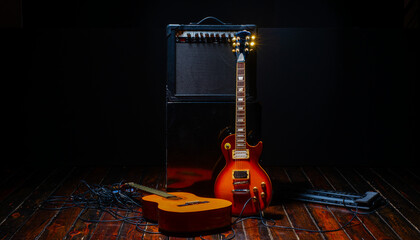 music show background with electric guitar and acoustic guitar and amplifier on dark background...