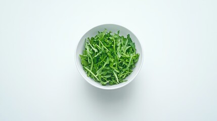 Obraz premium Fresh Green Arugula Leaves in a White Bowl on a Light Background