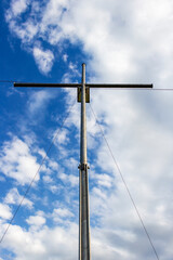 Metal Christian cross near the village of Krum, Municipality of Dimitrovgrad, Haskovo Province, southern Bulgaria, low-angle partial view on a cloudy background 