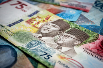 Red Seventy-five thousand rupiah. IDR 75,000, is a special denomination banknote printed in 2020 to commemorate the 75th anniversary of the independence of the Republic of Indonesia.