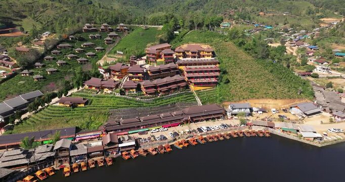 defaultAerial view of the Chinese village of Ban Rak Thai with tea plantations and a lake, Thailand