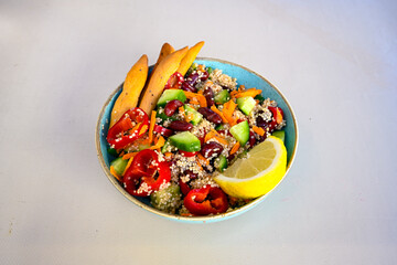 Green salad with arugula, lamb and tomatoes. Healthy vegan dish. Top view at table. Turkish Coban (choban) salata or Shepherds salad, Akdeniz salad in white bowl.