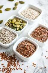 Fototapeta premium Colorful assortment of seeds displayed in elegant bowls on marbl