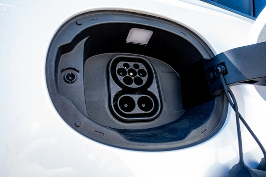 An electric vehicle (EV) charging high-voltage energy at an EV charging station replenishes its battery using direct current (DC) power delivered through a charging cable to the vehicle's battery