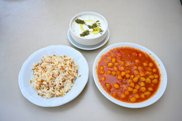 Traditional turkish bulgur pilaf with tomato sause in plate (Turkish name; bulgur pilavi, meyhane pilavi) Pirinc pilavi. Pilavustu tavuk, nohut, kuru fasulye, ciger.
