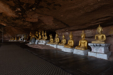 The Naga Cave in Bueng Kan, Thailand, features serpent-like rock formations tied to Naga mythology,...
