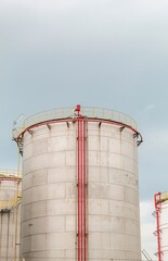 industrial chemical tank or oil or gas storage tank in a factory. industrial tank with clear sky background. photo with low angle object and portrait view